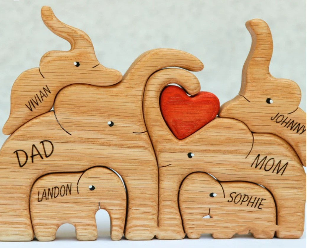 A Wooden Statue Of The Elephant Family At Home